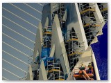 Builders on the scaffolding of a curved modern building