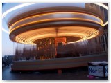 Fairground carousel blurred in motion at dusk