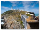 Clifftop path and railings leading to a lighthouse